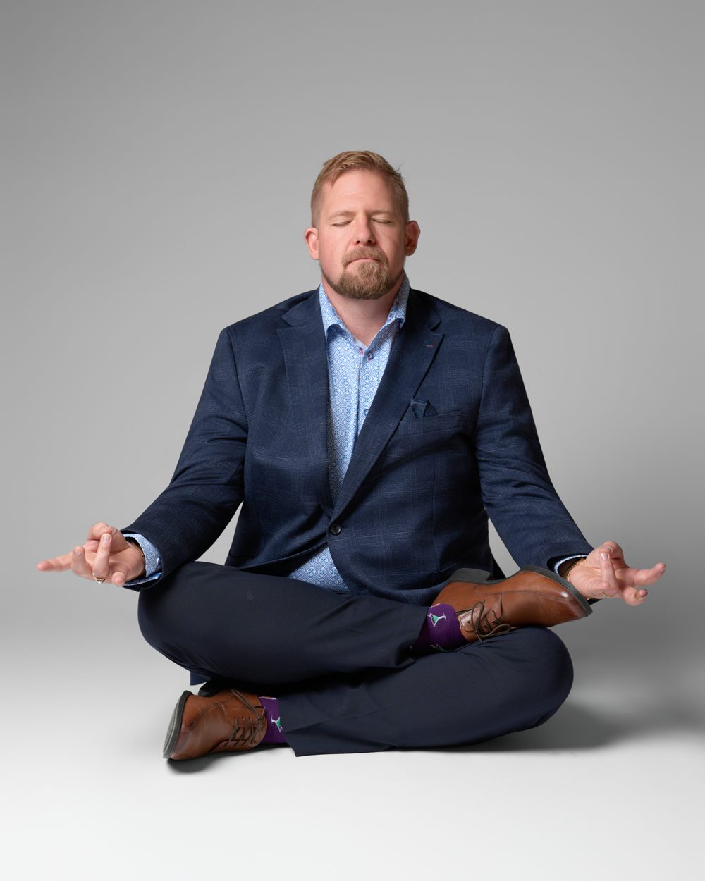 Jon sitting cross legged, calm